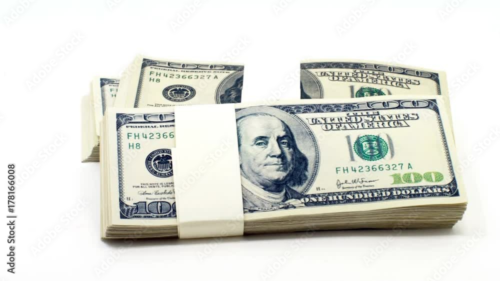 Falling stacked piles of bills of one hundred dollars Falling stacked piles of bills of one hundred dollars