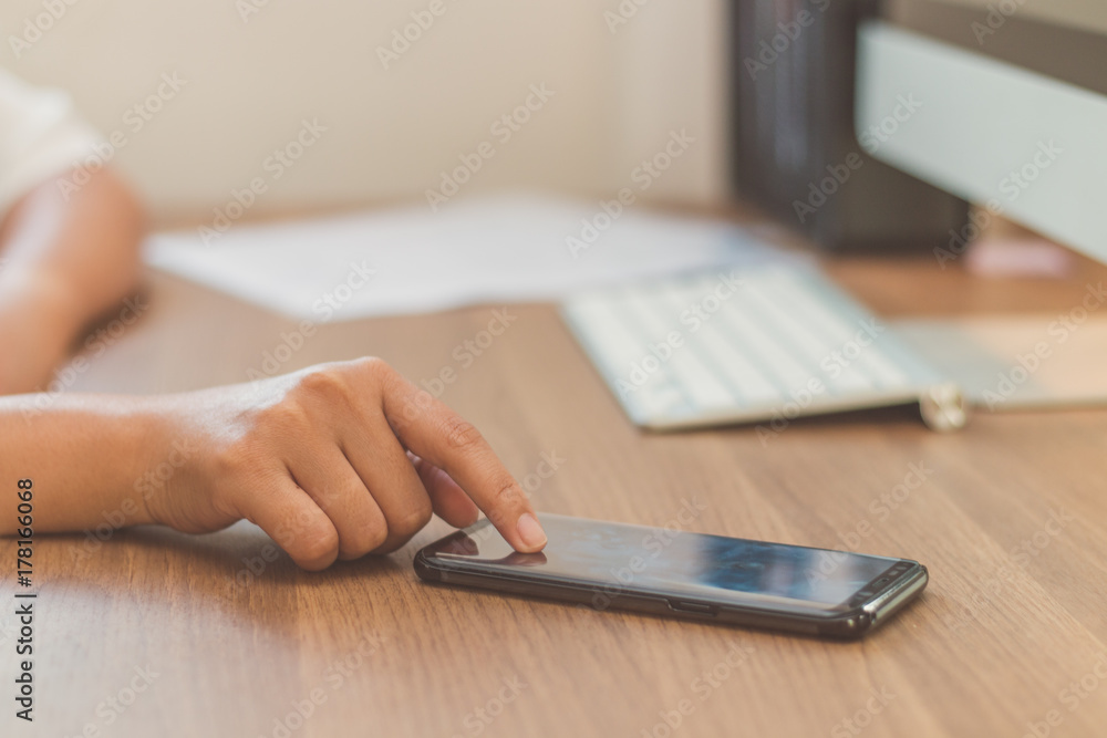 Fototapeta premium The worker woman touching screen on smart phone