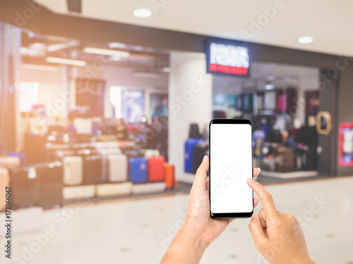 Hand holding smartphone on shopping mall background blurred, Hand ready to take a photo
