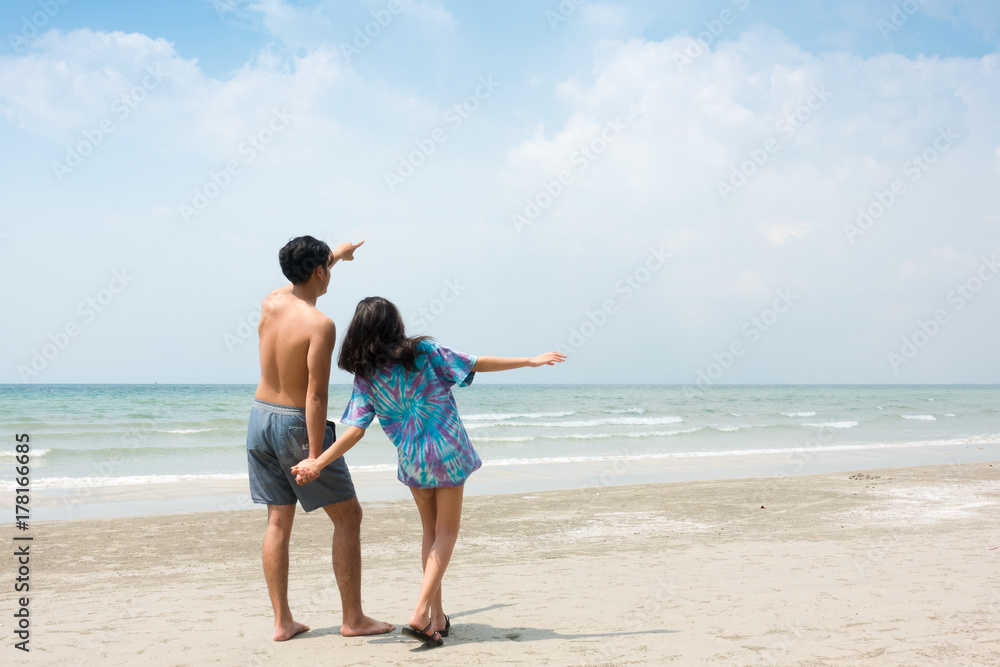 Young couple in love, playing together on the beach Young couple in love, playing together on the beach