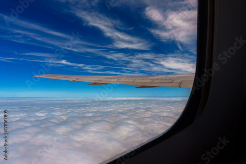aerial view of blue sky with clouds from window of jet flight