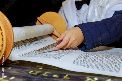 reading torah, bar mitzva down and praying photo