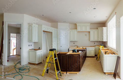Custom kitchen cabinets in various stages of installation base for island in center