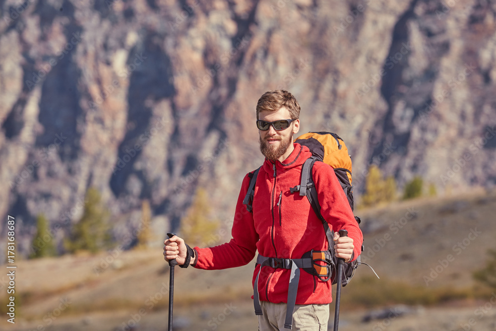 Tall backpacker with poles in hand. Tall backpacker with poles in hand.