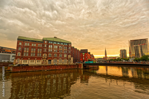 Photography Beautiful sunset at riverside of Hamburg with dramatic sky.