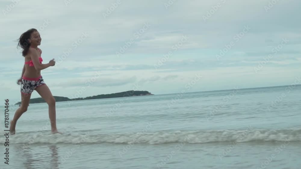 Joyful happy young girl running on water sea spray slow motion stock footage video Joyful happy young girl running on water sea spray slow motion stock footage video