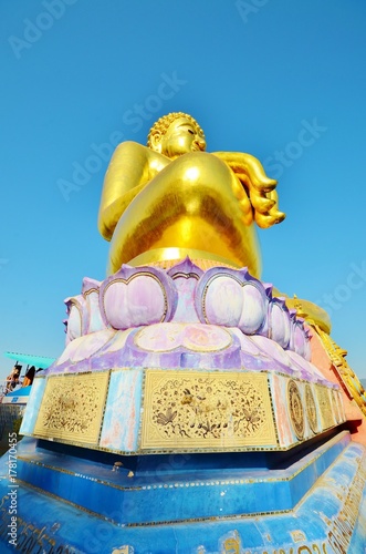 Золота статуя сидящего будды в Phra Chiang Saen Si Phaendin с необычных ракурсов