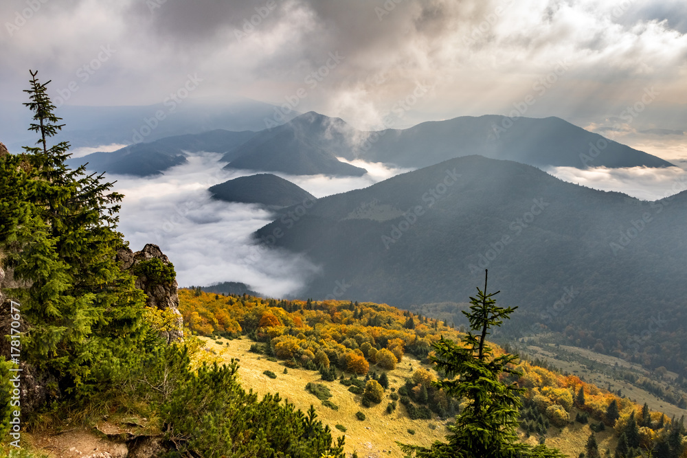 Beautiful morning mountain landscape with low clouds in valley