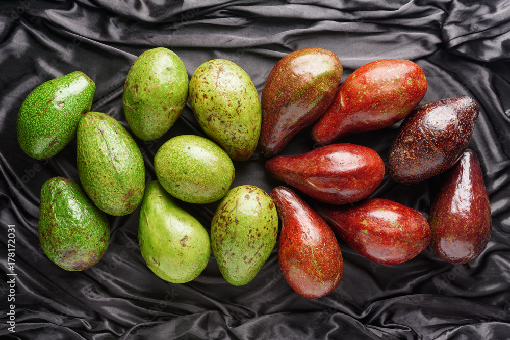 Colorful fresh ripe avocados on dark background. Healthy eco food Colorful fresh ripe avocados on dark background. Healthy eco food