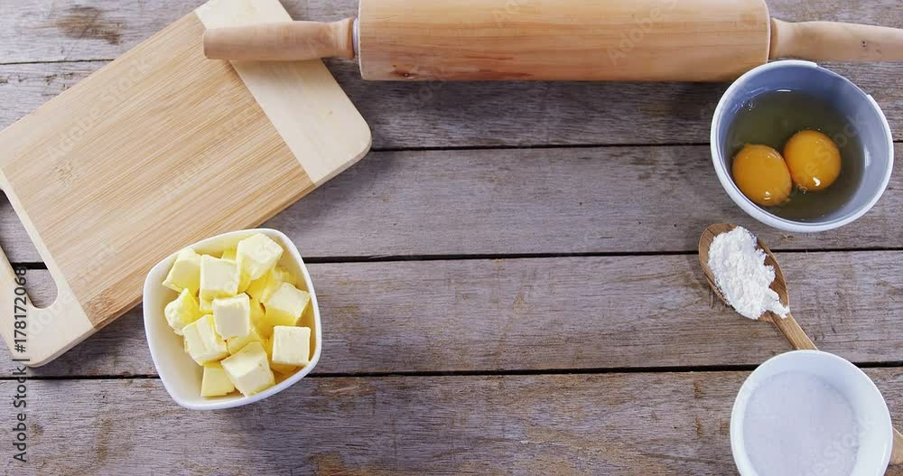 Butter cubes and egg yolk on a wooden table Butter cubes and egg yolk on a wooden table