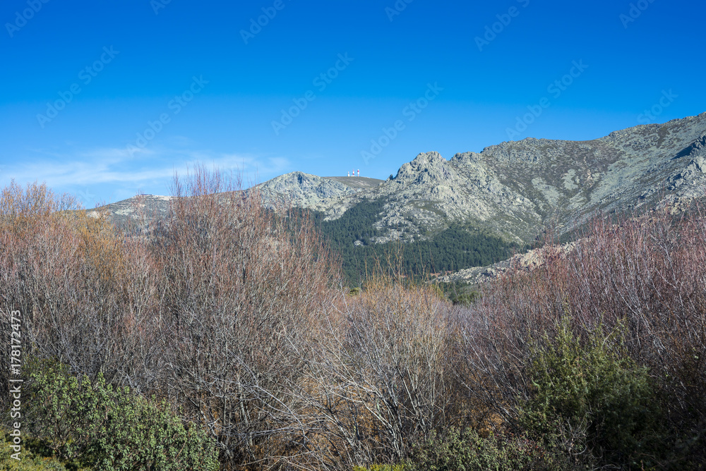 Views of Guadarrama Mountains (Madrid, Spain) with La Bola del Mundo peak, La Barranca Valley and La Maliciosa peak in the background. Photo taken from the River Navacerrada Views of Guadarrama Mountains (Madrid, Spain) with La Bola del Mundo peak, La Barranca Valley and La Maliciosa peak in the background. Photo taken from the River Navacerrada