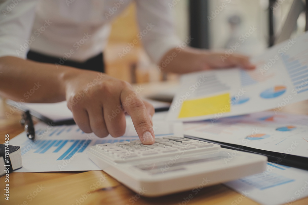 Accountant verify the business and saving money stacking gold coins with calculator. Accountancy Concept Accountant verify the business and saving money stacking gold coins with calculator. Accountancy Concept