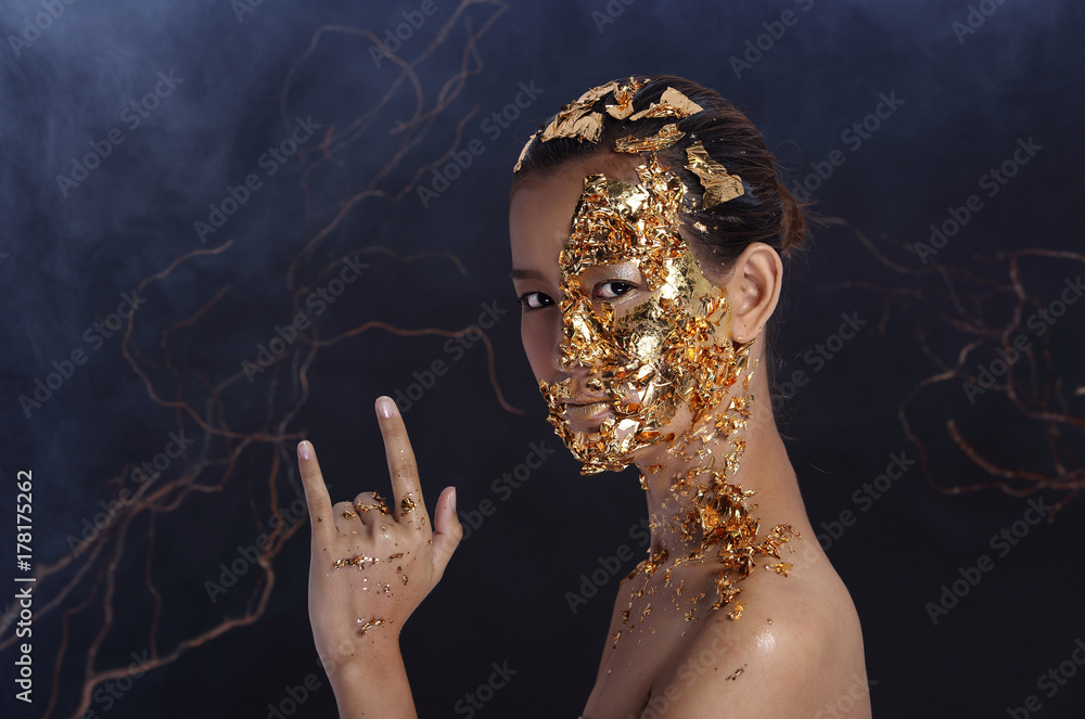 Gold Leaf High fashion style on Asian Woman Face dark mystery look