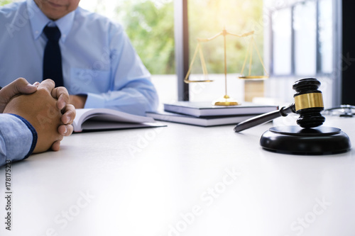 Obraz na plátne Legal counsel presents to the client a signed contract with gavel and legal law