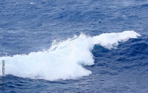 Blue ocean wave on Windy Rough sea day. Cruise ship Vacation. Big surf.