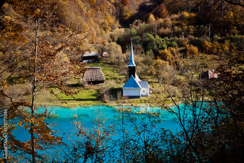 church with its cemetery under contaminated water in Geamana, Romania. Polluted lake with mining residuals that destroyed a village. photo