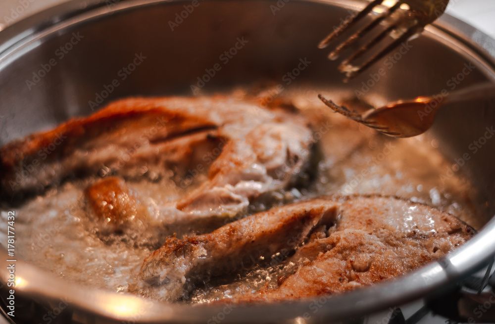Fototapeta premium Fillet of fresh fish carp on a plate in flour ready for cooking.