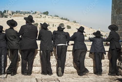 Orthodox Jew students of Yeshivah stand in front of the Western Wall photo