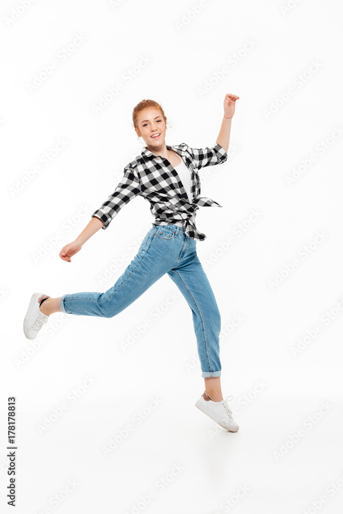 Full length image of happy ginger woman in shirt