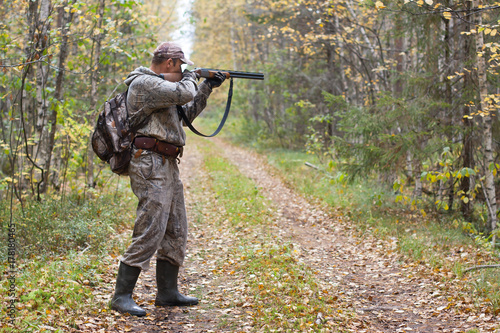 hunter taking aim from a shotgun