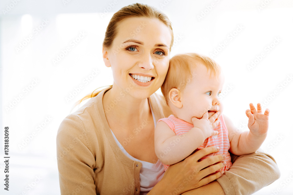 Loving mother looking happy while being with her baby Loving mother looking happy while being with her baby