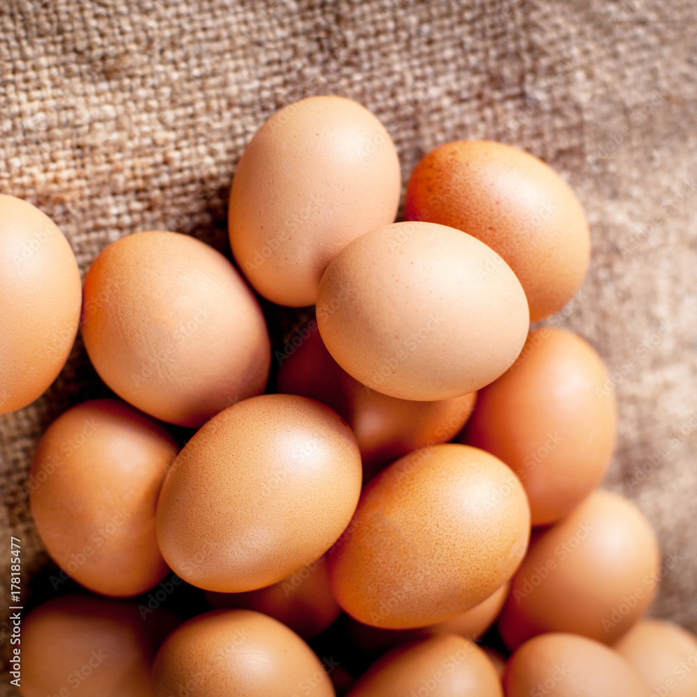 Large brown Eggs on burlap background closeup Large brown Eggs on burlap background closeup