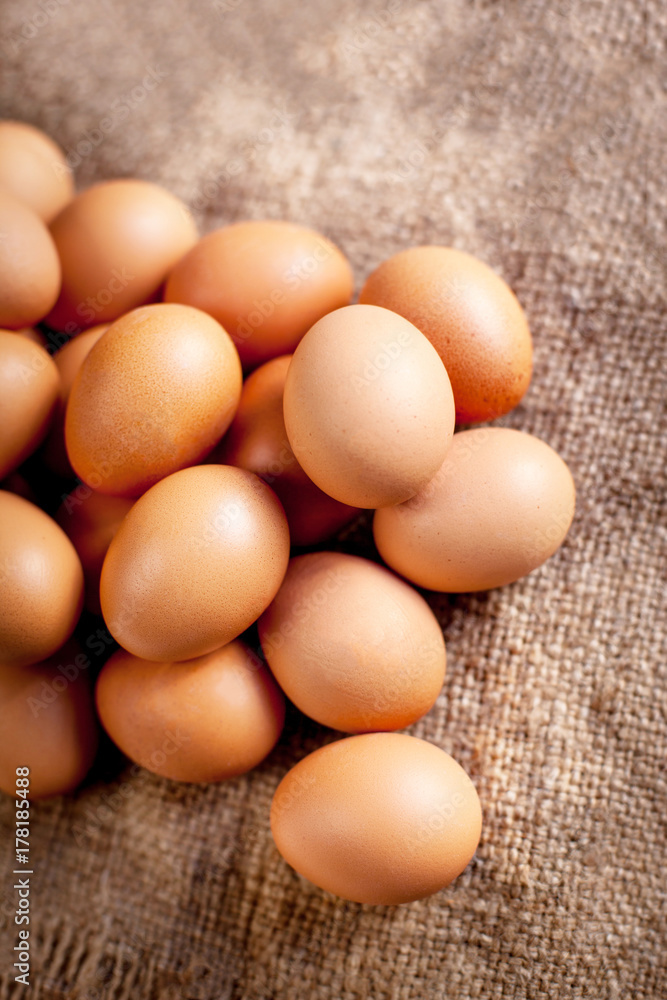Large brown Eggs on burlap background closeup Large brown Eggs on burlap background closeup