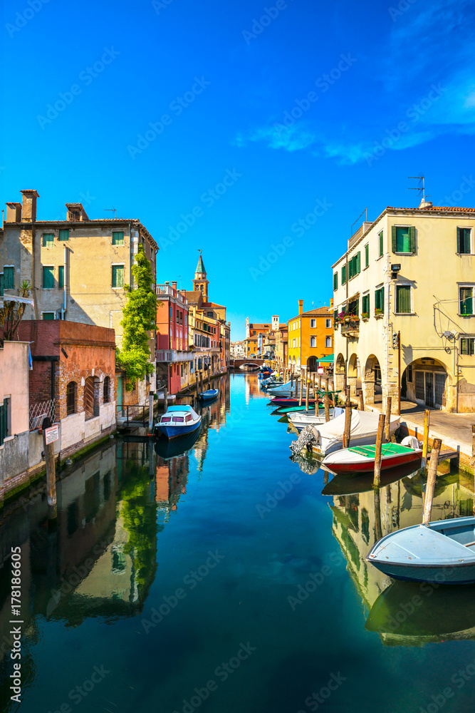 Chioggia town in venetian lagoon, water canal and church. Veneto, Italy