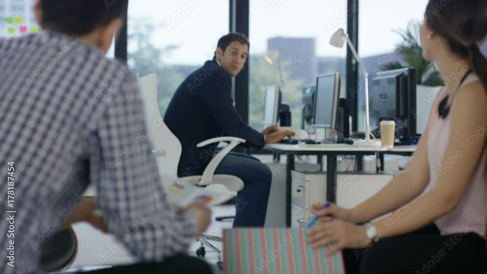 Professional team looking over figures & projections in business meeting Professional team looking over figures & projections in business meeting
