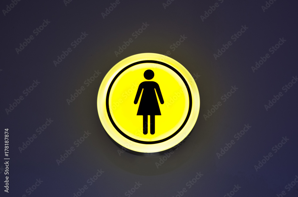 Toilet female signs on the abstract wall background. Copy space. Woman