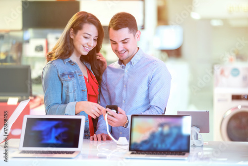 Couple shopping for latest laptop and smartphone