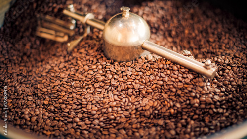 Coffee roasting, fresh coffee beans background