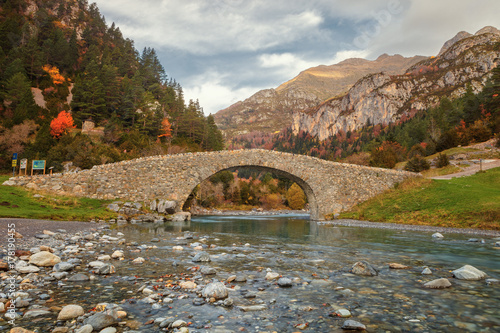 Romanesque bridge in the valley of Bujaruelo, XIII century on the Ara river, in the Aragonese Pyrenees, Huesca, Spain photo