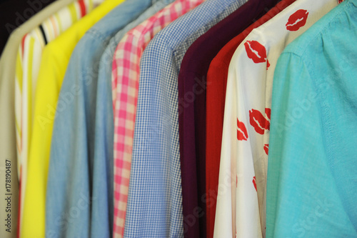 Background texture from a row of colored shirts and blouses on a hanger photo