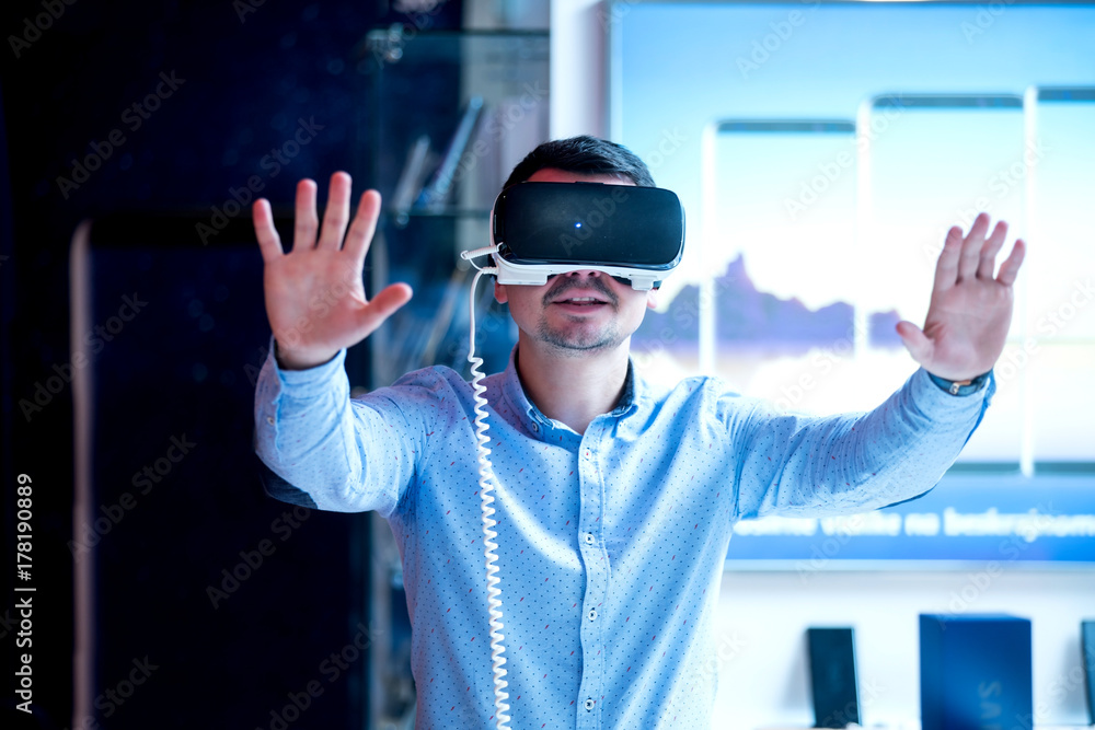 young guy having fun trying latest 360 vr headset young guy having fun trying latest 360 vr headset