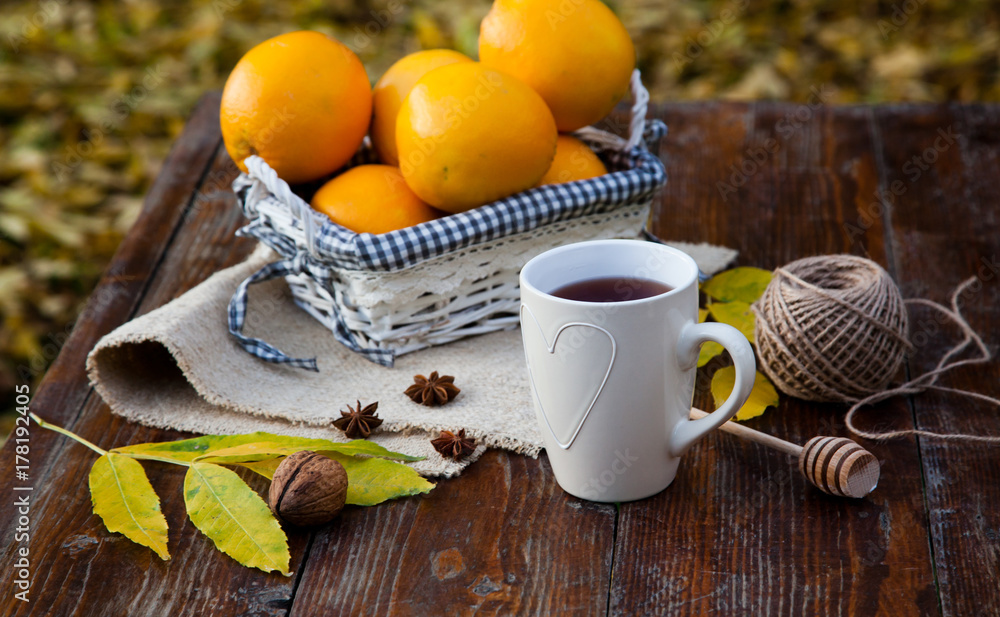 tea with lemon, honey, oranges, autumn leaves on woodenbackground tea with lemon, honey, oranges, autumn leaves on woodenbackground
