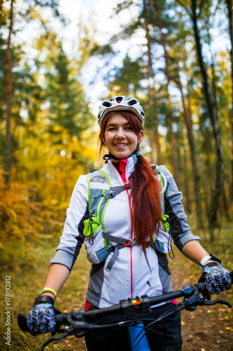 Image ofa girl in helmet riding bicycle