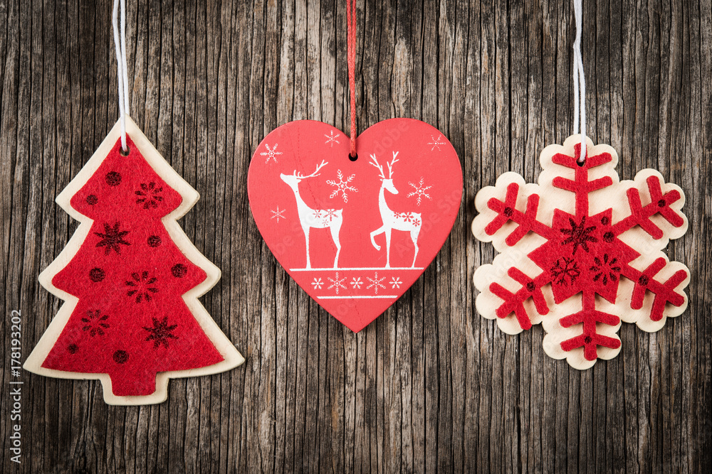 Red Christmas decorations over rustic wood Red Christmas decorations over rustic wood