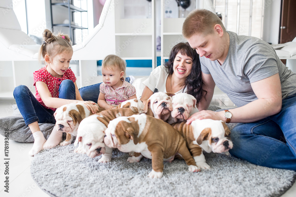 Nice scene of the family and the puppy on the carpet at home