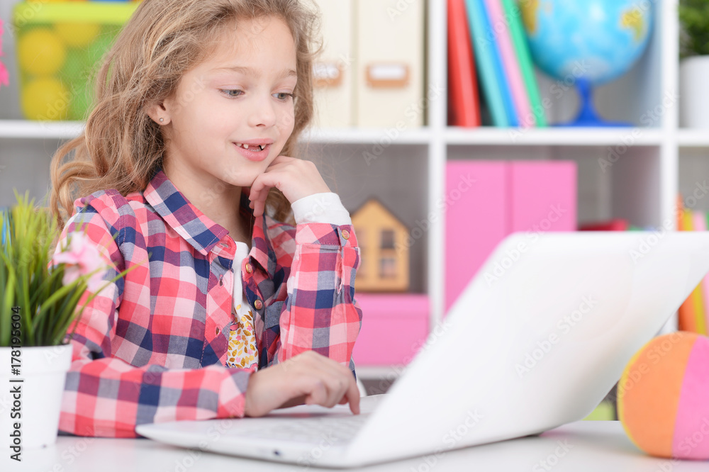 Little girl using modern laptop Little girl using modern laptop