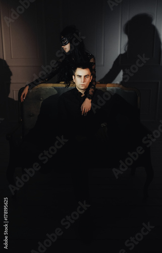 woman  with  theatrical mask and handsome man