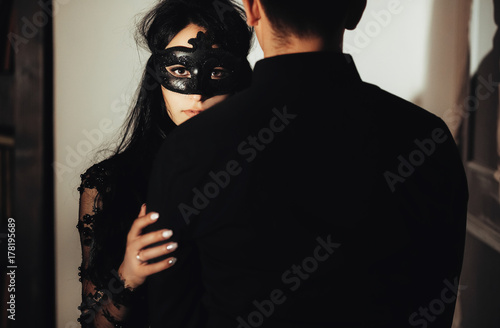 woman  with  theatrical mask and handsome man