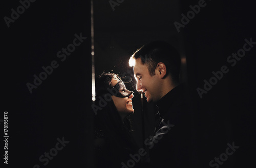 woman with theatrical mask and handsome man