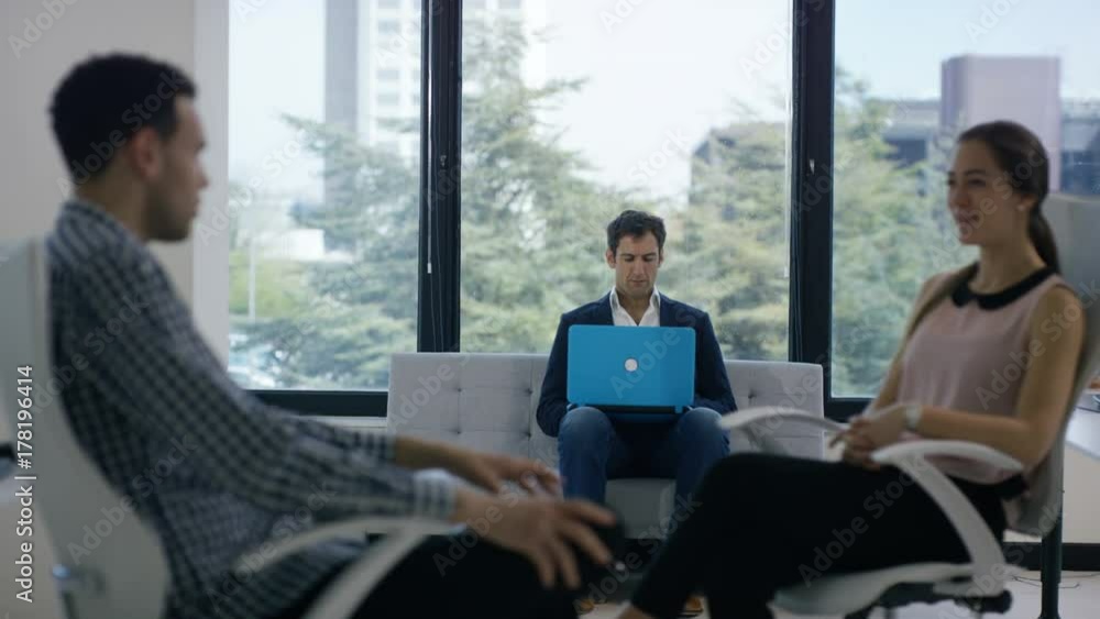 Business team in office meeting, looking at sales figures & discussing ideas Business team in office meeting, looking at sales figures & discussing ideas