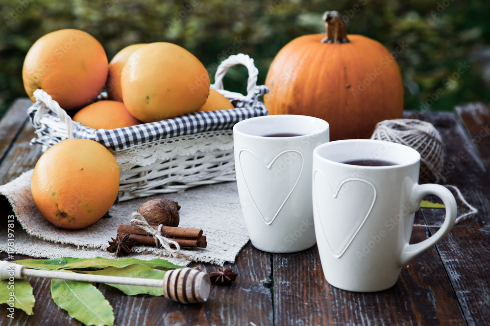 tea with lemon, honey, oranges, autumn leaves on woodenbackground tea with lemon, honey, oranges, autumn leaves on woodenbackground