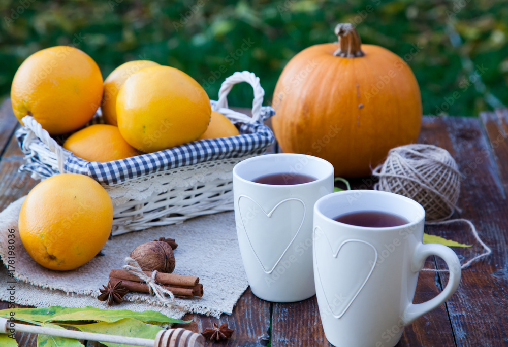 tea with lemon, honey, oranges, autumn leaves on woodenbackground tea with lemon, honey, oranges, autumn leaves on woodenbackground
