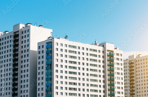 Residential houses, identical balconies and windows.