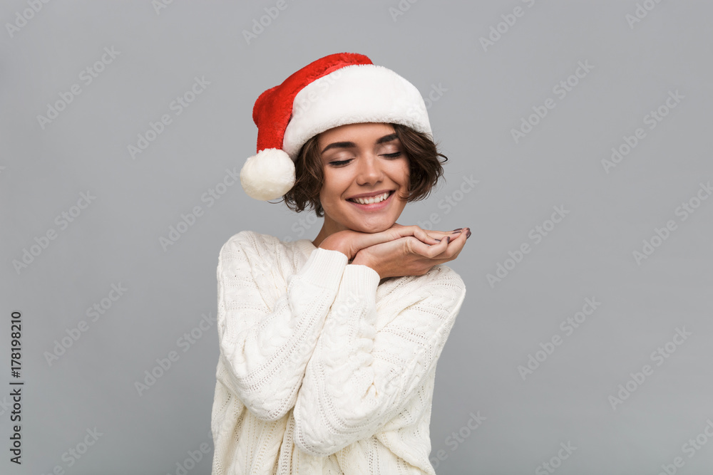 Portrait of a lovely smiling girl in christmas hat posing Portrait of a lovely smiling girl in christmas hat posing