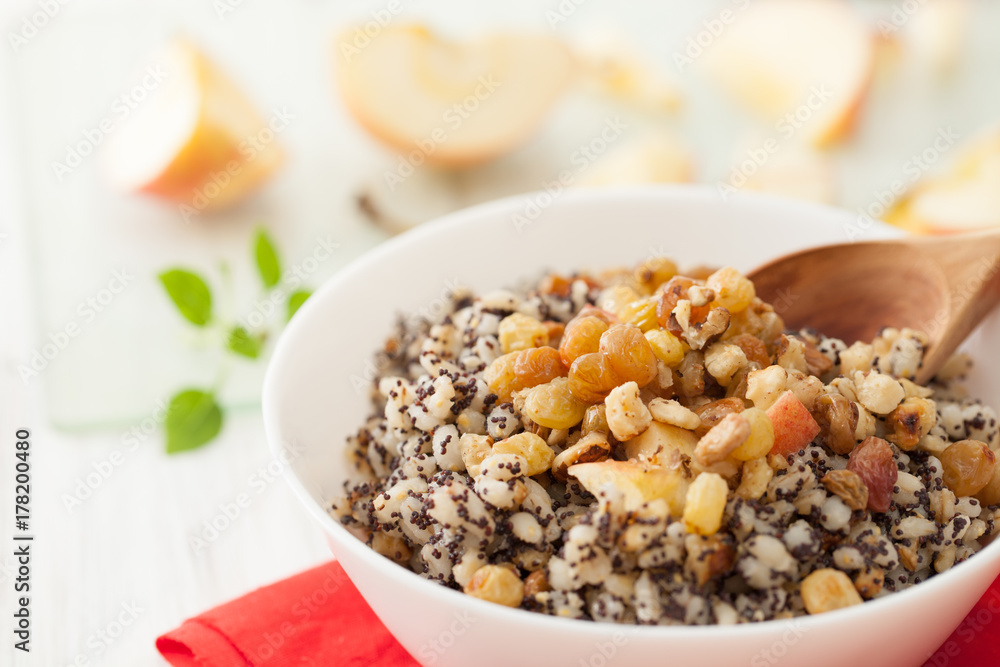 Christmas porridge with a wooden spoon and apples Christmas porridge with a wooden spoon and apples