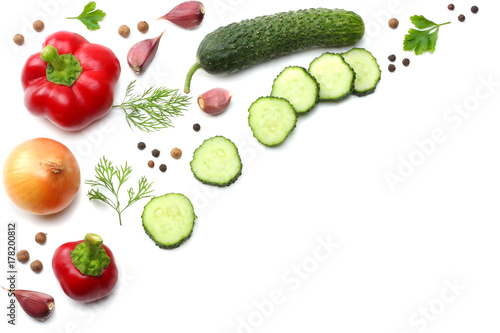 mix of sliced cucumber, garlic, sweet bell pepper and parsley isolated on white background. top view